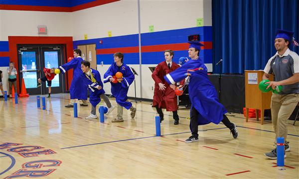 Students play dodgeball in the gym